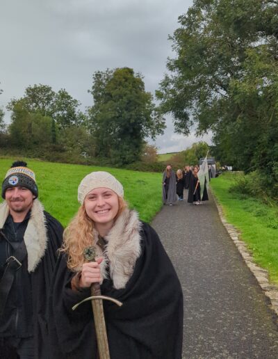 Stark cloaks holding swords